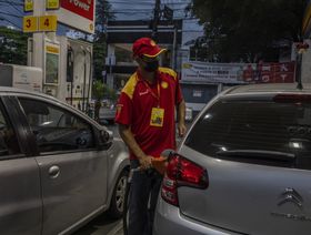 عامل يزوّد سيارة بالوقود في محطة "شل"، البرازيل - المصدر: بلومبرغ