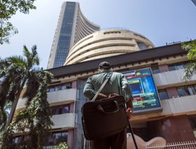 أحد المشاة أمام مبنى بورصة بومباي الهندية - المصدر: بلومبرغ