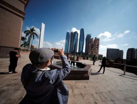 سائح يلتقط صوراً لأبراج الإمارات من فندق قصر الإمارات في أبوظبي. الإمارات العربية المتحدة - المصدر: رويترز