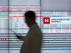 زائر يمر أمام شاشة إلكترونية تعرض أسعار الأسهم في بورصة موسكو. موسكو، روسيا - المصدر: بلومبرغ