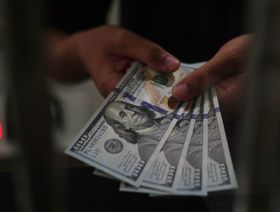 الدولار الأميركي يتراجع إلى مستوى متدن مع استمرار أزمة الرسوم