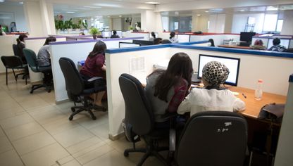 مجموعة من الأشخاص يستخدمون أجهزة الكمبيوتر لإنهاء مهام عملهم - المصدر: غيتي إيمجز
