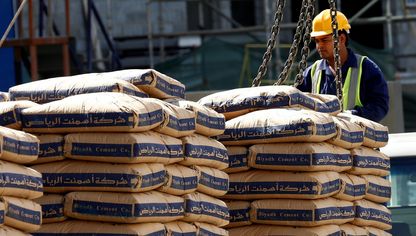 عامل يشرف على تحميل أكياس أسمنت من صناعة شركة 'أسمنت الرياض' بواسطة رافعة في موقع إنشاءات، الرياض، السعودية - رويترز 