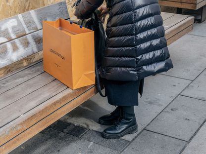 متسوق يحمل حقيبة \"لويس فويتون\" في منطقة غرابن في فيينا، النمسا - المصدر: بلومبرغ