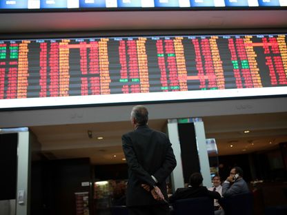 مراقب لشاشة تعرض أسعار أوراق مالية. - المصدر: بلومبرغ