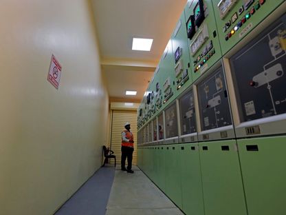 عامل يراقب الأجهزة في مركز التحكم الرئيسي بمحطة بنبان للطاقة الشمسية الكهروضوئية في أسوان، مصر - المصدر: رويترز