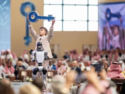 طفل يرفع \"مفتاح الازدهار\"، رمز النسخة التاسعة لقمة مبادرة مستقبل الاستثمار، بعد استلامه من روبوت، في رمزية إلى تلاقي الذكاء الاصطناعي مع الطموح الإنساني لبناء مستقبل مزدهر - الشرق