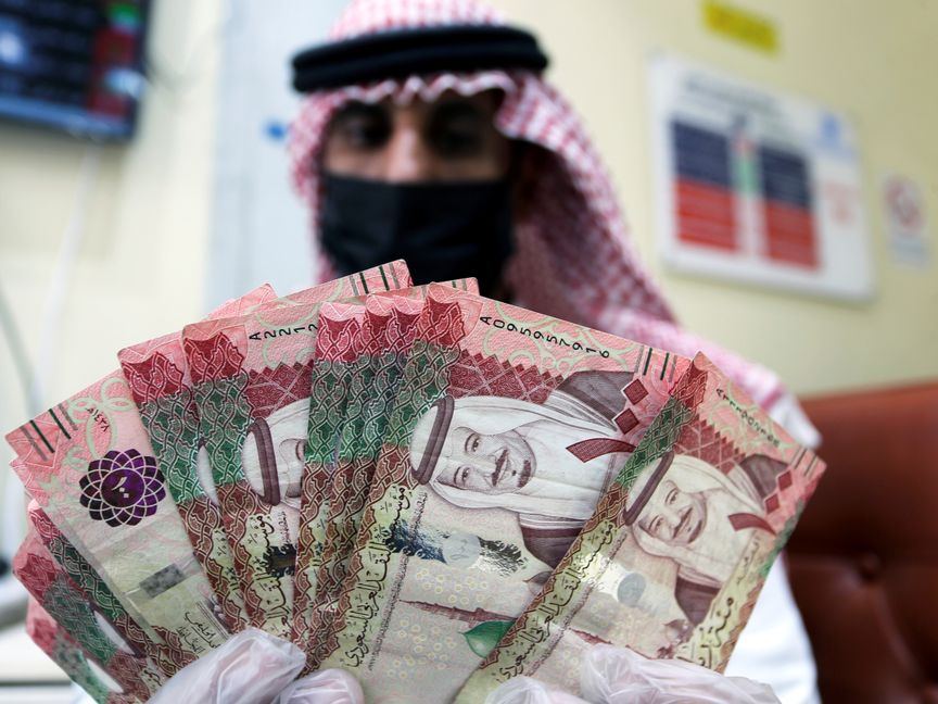 موظف في شركة صرافة يعد أوراق نقد سعودية من فئة 100 ريال - المصدر: بلومبرغ