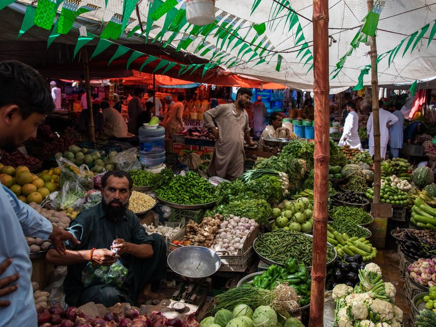 باعة يبيعون خضروات وسلعاً أخرى في سوق بكراتشي، باكستان - المصدر: بلومبرغ