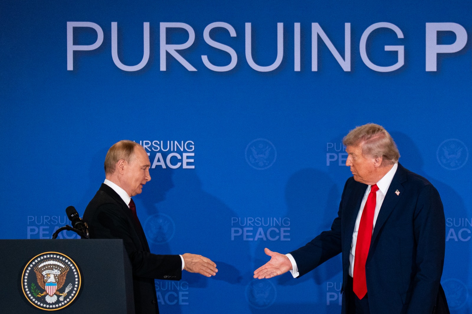 الرئيس الأميركي يصافح نظيره الرئيس فلاديمير بوتين خلال مؤتمر صحفي في ألاسكا، الولايات المتحدة، 15 أغسطس 2025. - بلومبرغ